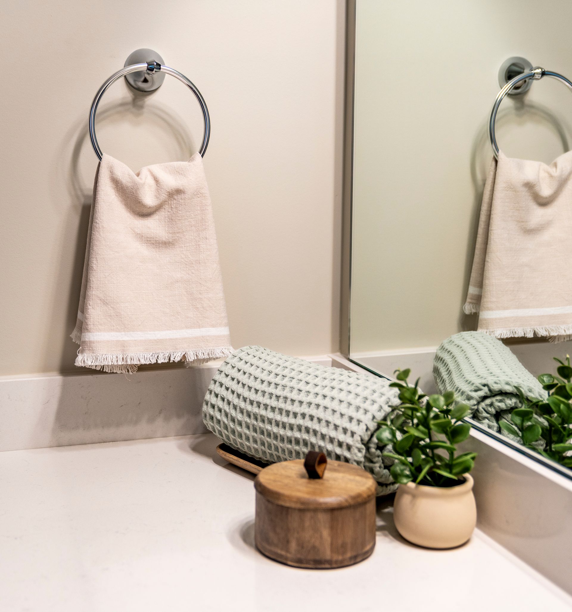 Photo of an arrangement of towels and more on the bathroom counter