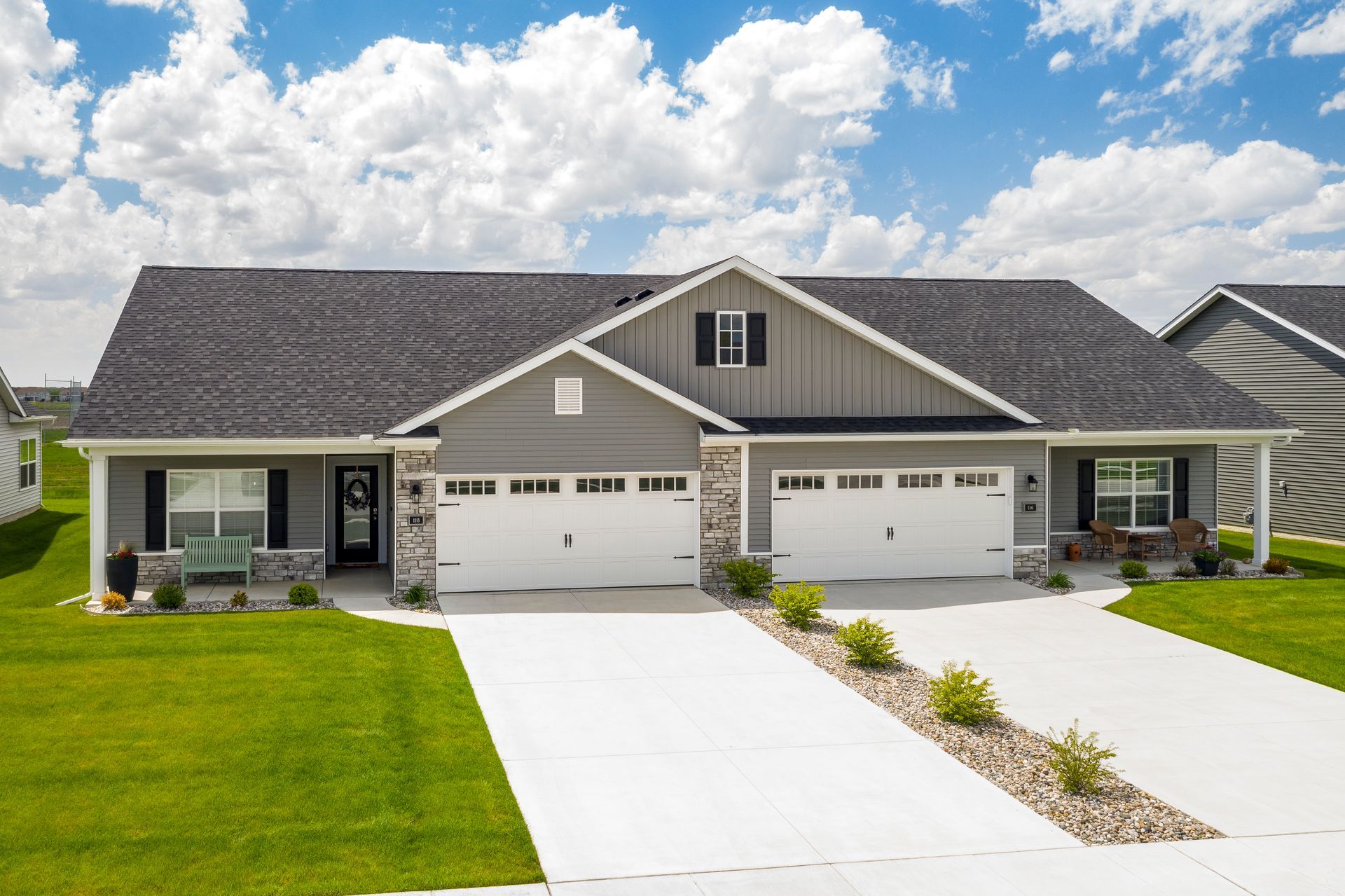 Photo of a couple of duplexes showing long driveways leading up to garages
