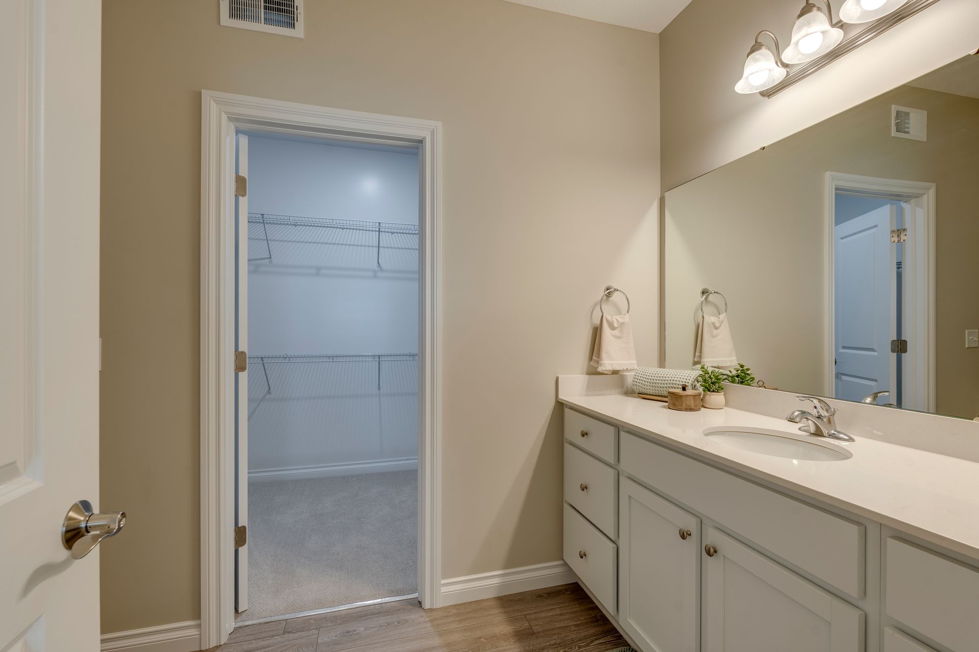 Photo of a bathroom with a walk-in closet in the background