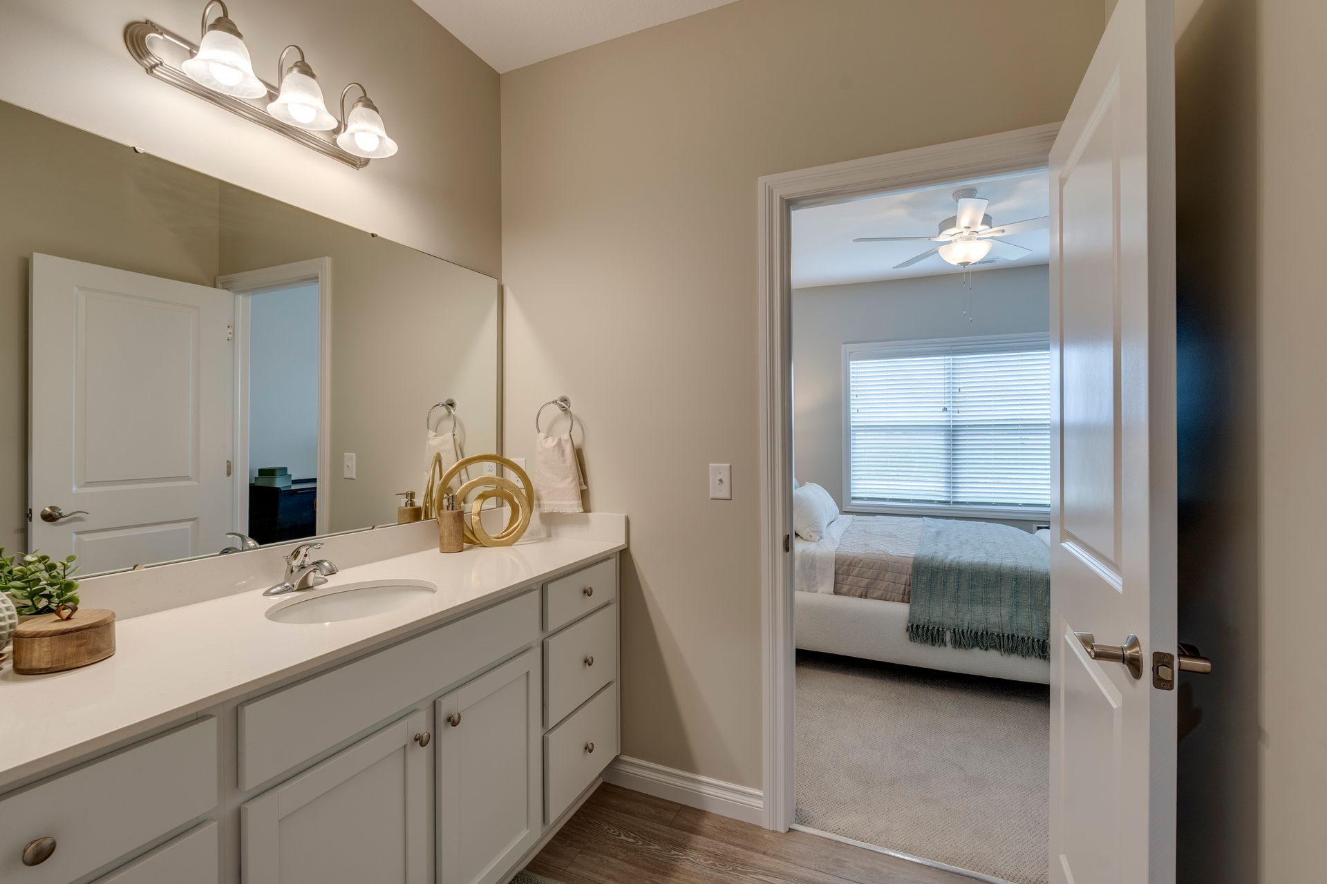 Photo of the bathroom counter, showing a wide counter and the bedroom in the background