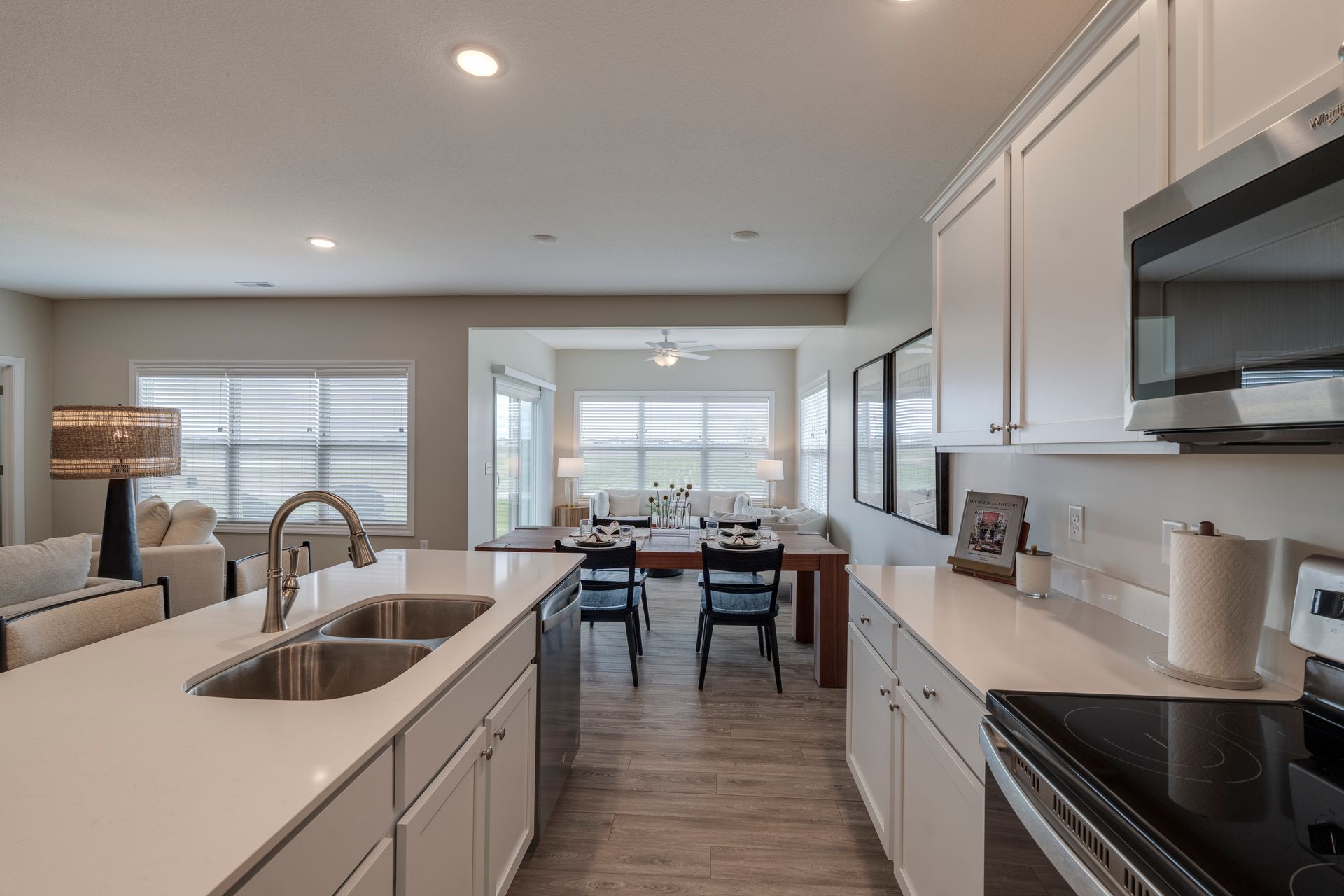 Photo of  the kitchen showing the dining table in the middle ground and a lounge area in the background