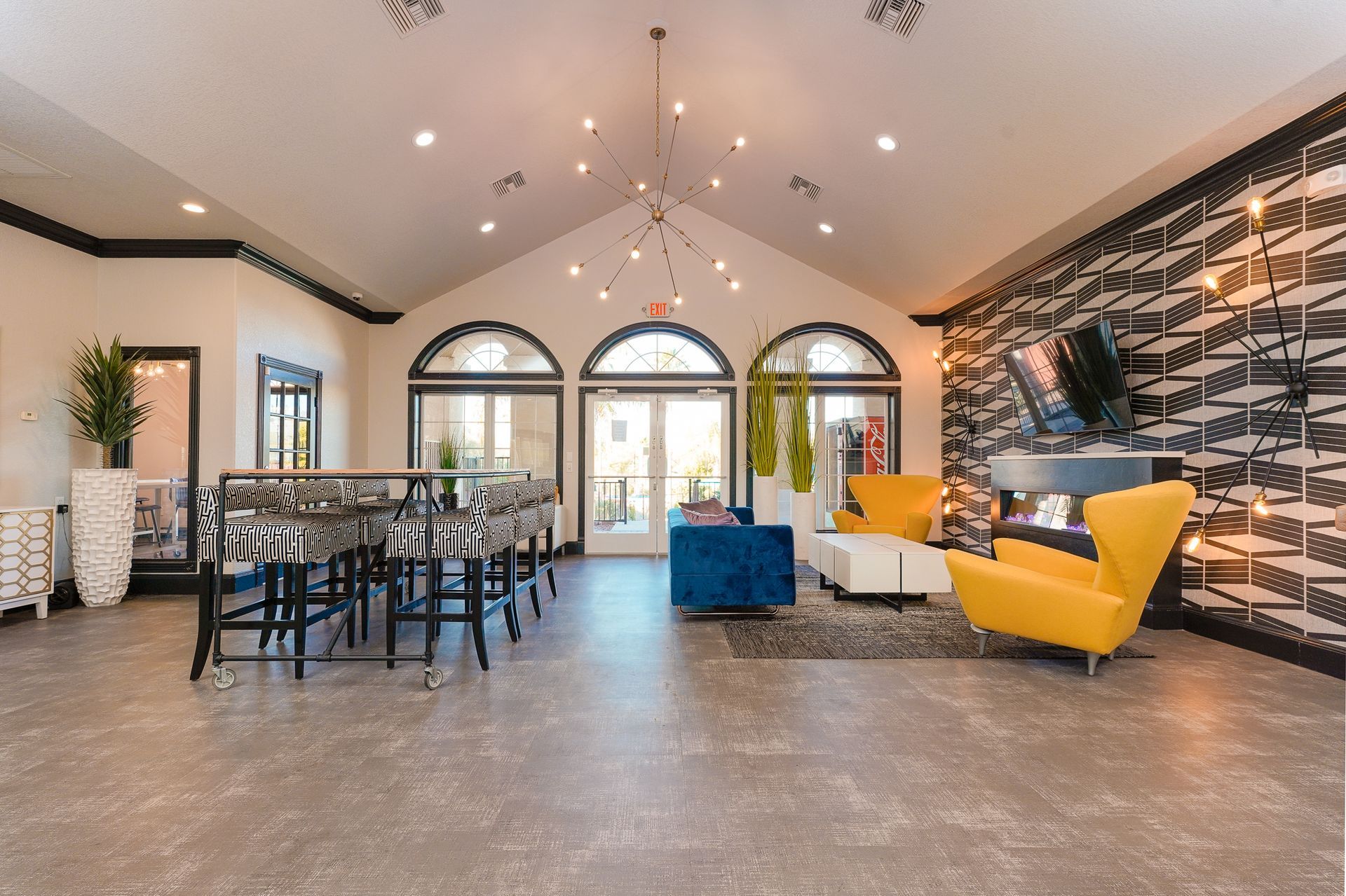 A large living room with a vaulted ceiling and lots of furniture.