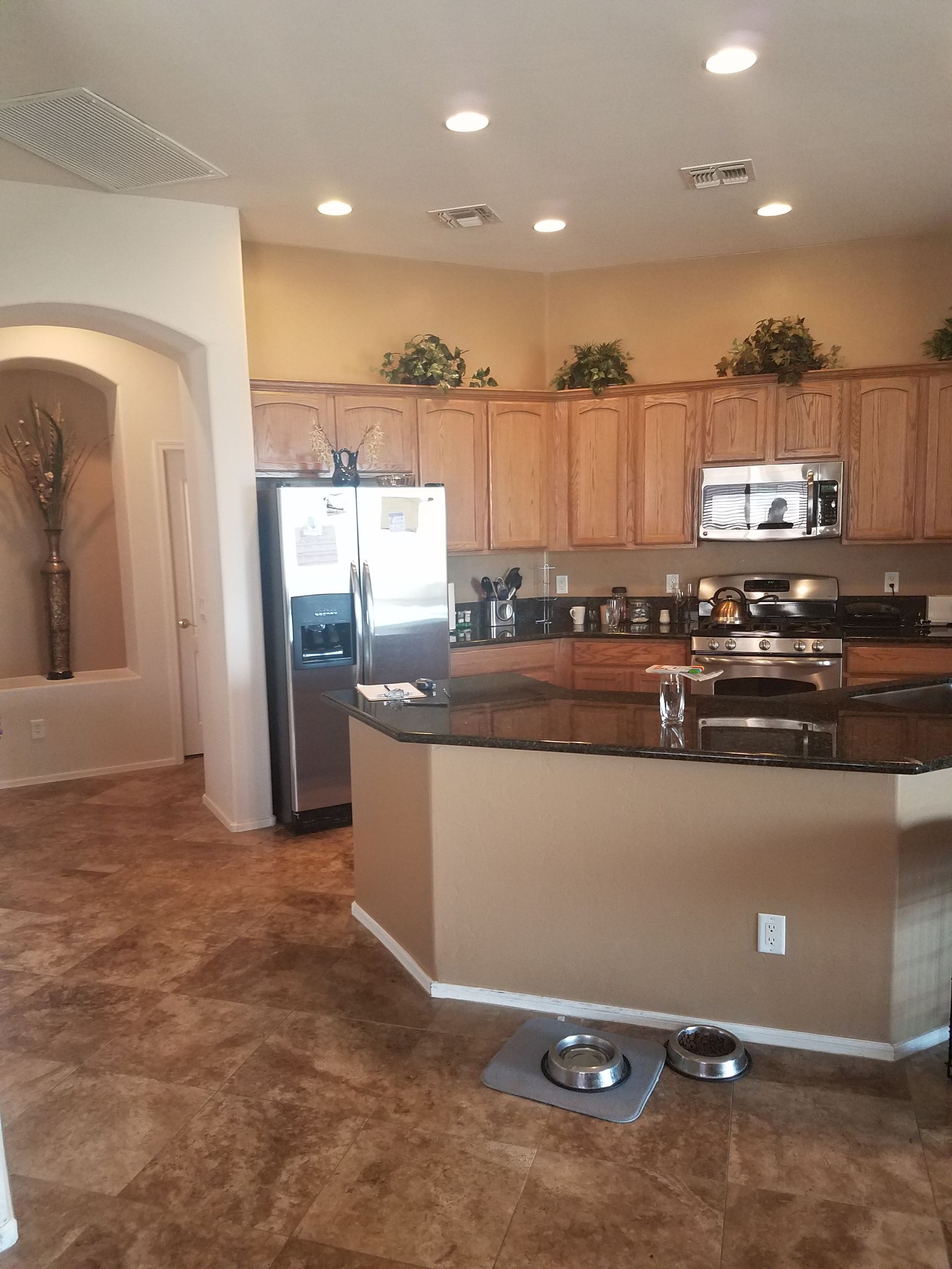 A kitchen with stainless steel appliances and wooden cabinets