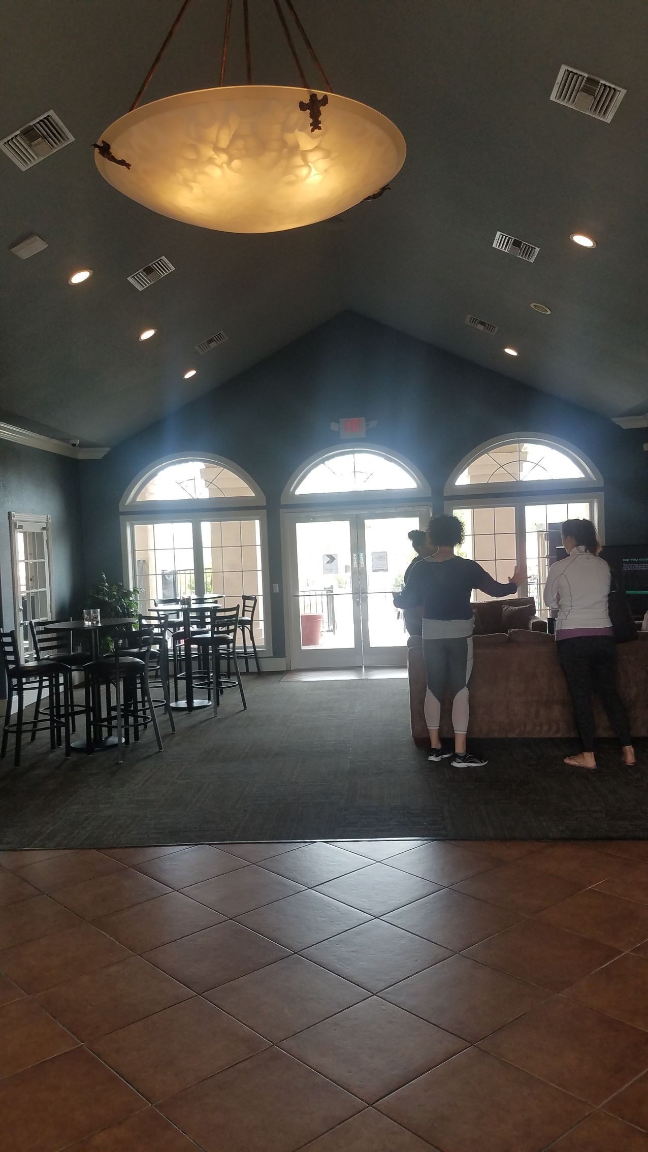 A group of people are standing at a counter in a restaurant.