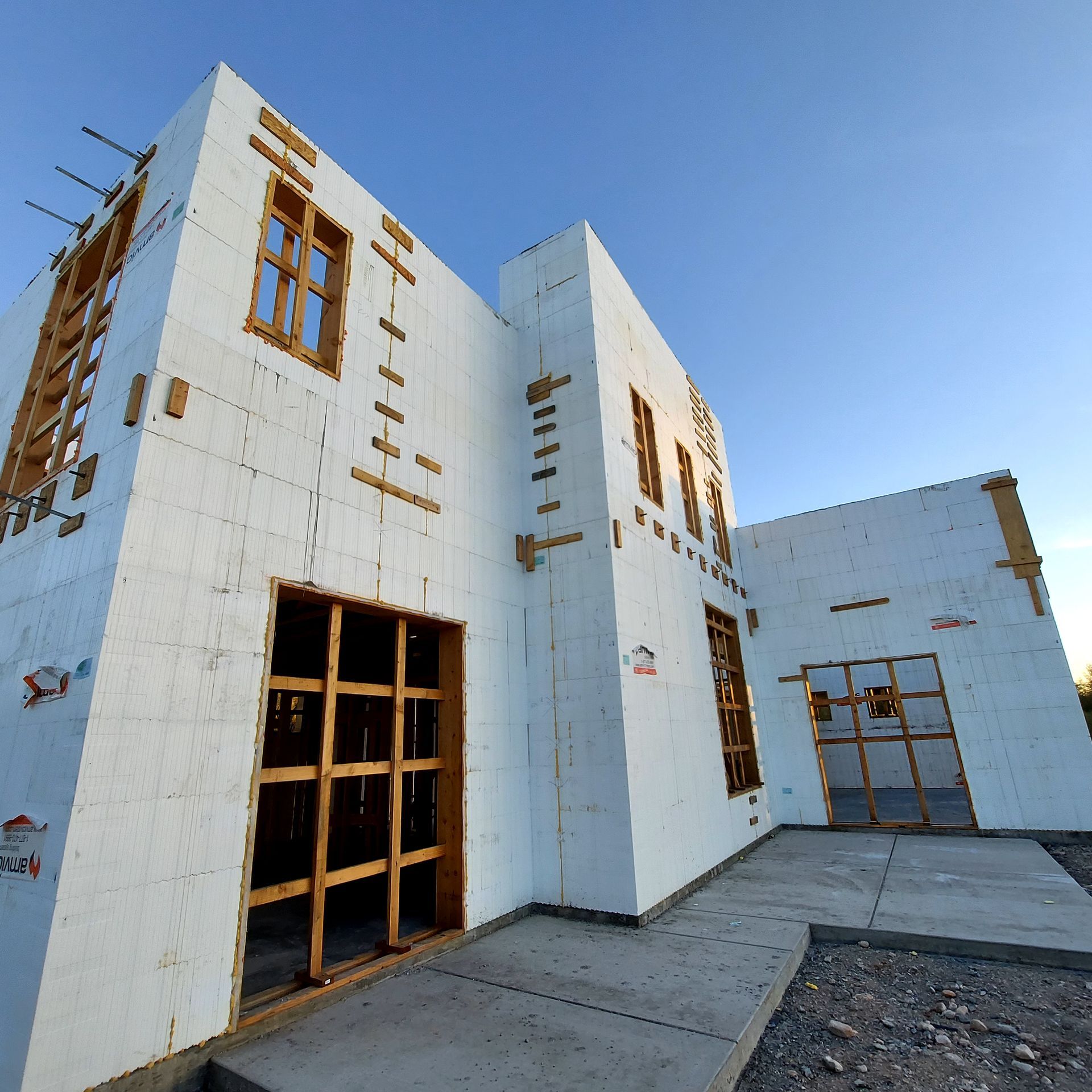 A large white building with a blue sky in the background