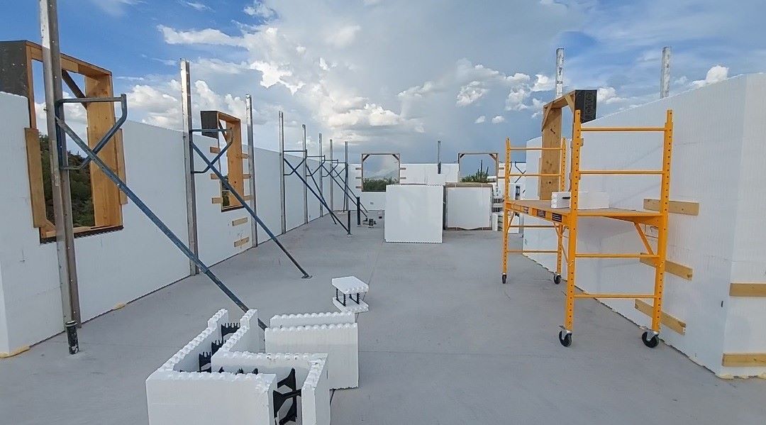 A construction site with a lot of scaffolding and chairs.