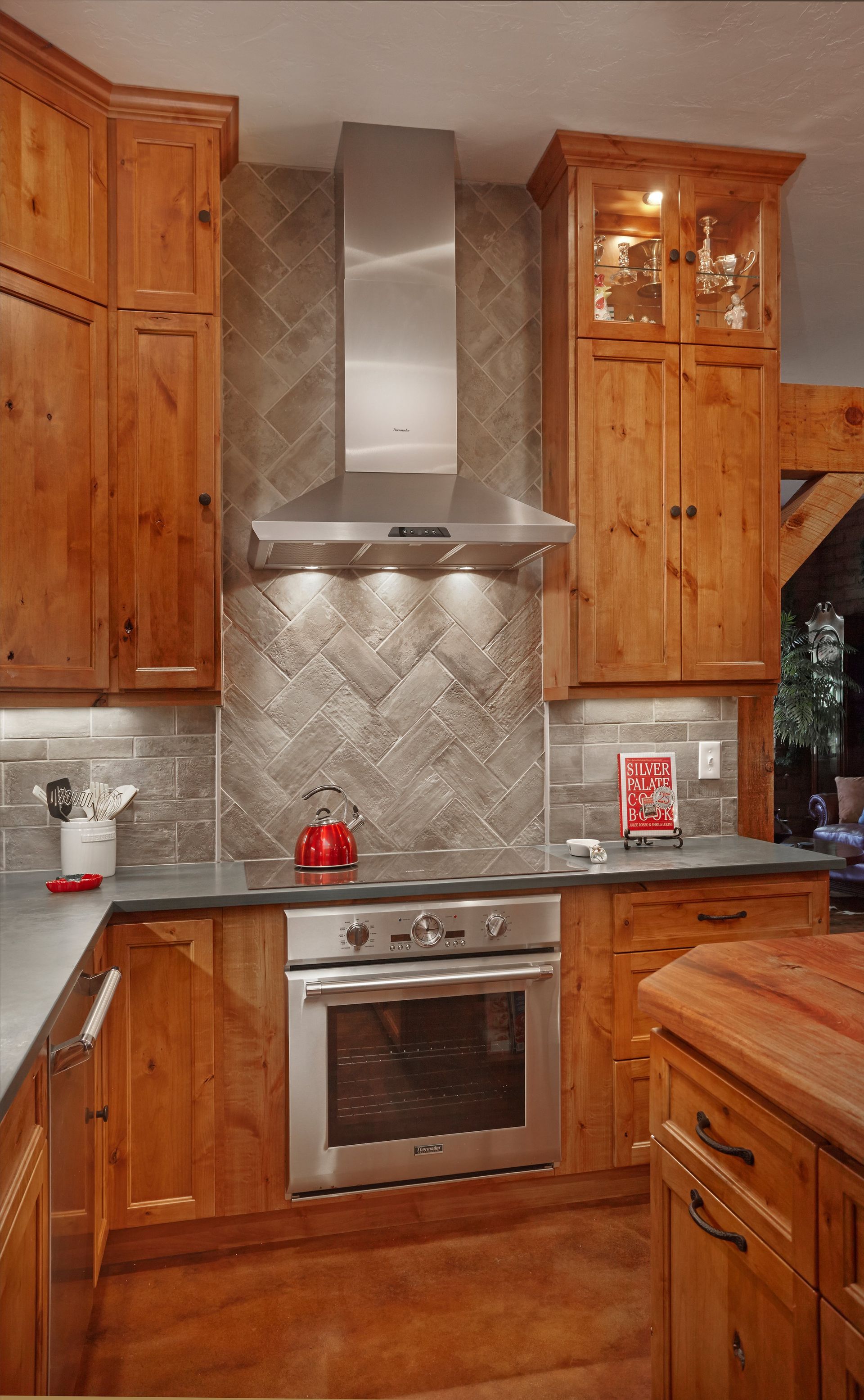 A kitchen with stainless steel appliances and wooden cabinets