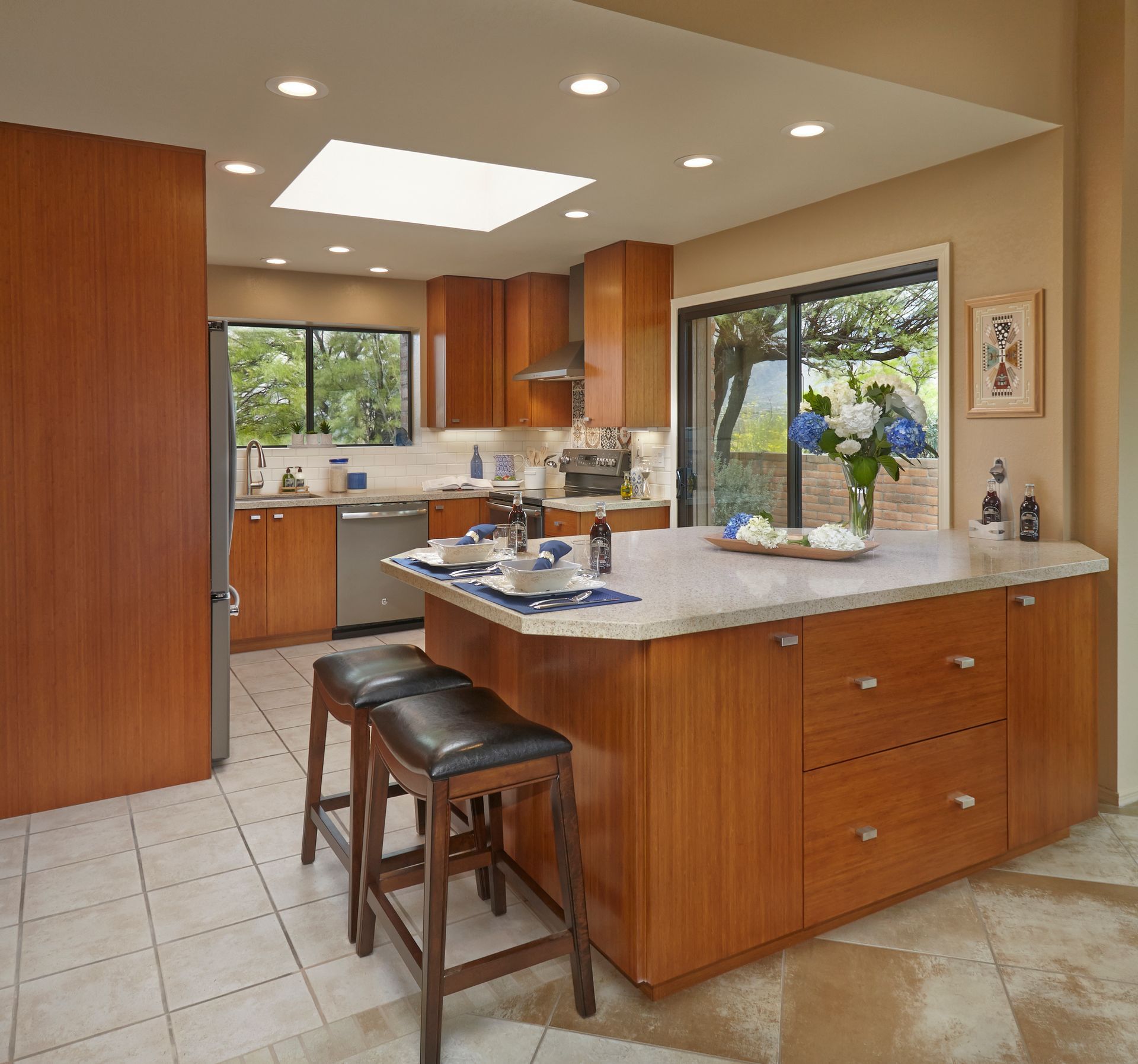 A kitchen with a large island and stools