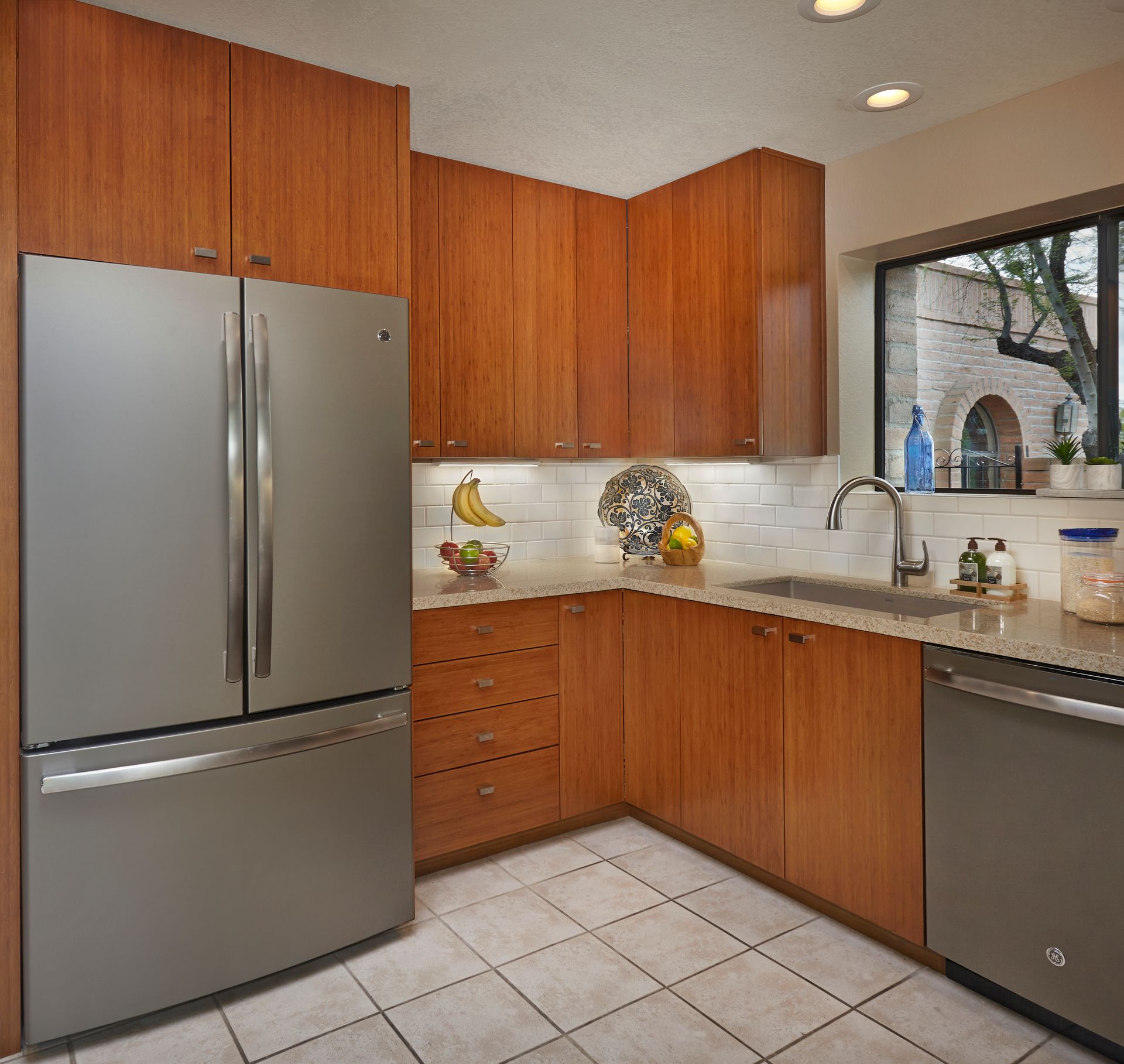 Kitchen with wood cabinets, stainless steel appliances, and a window.