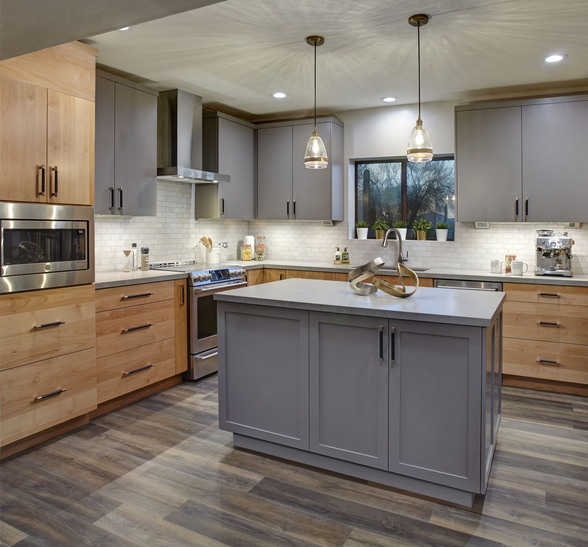 A kitchen with gray cabinets and wooden cabinets
