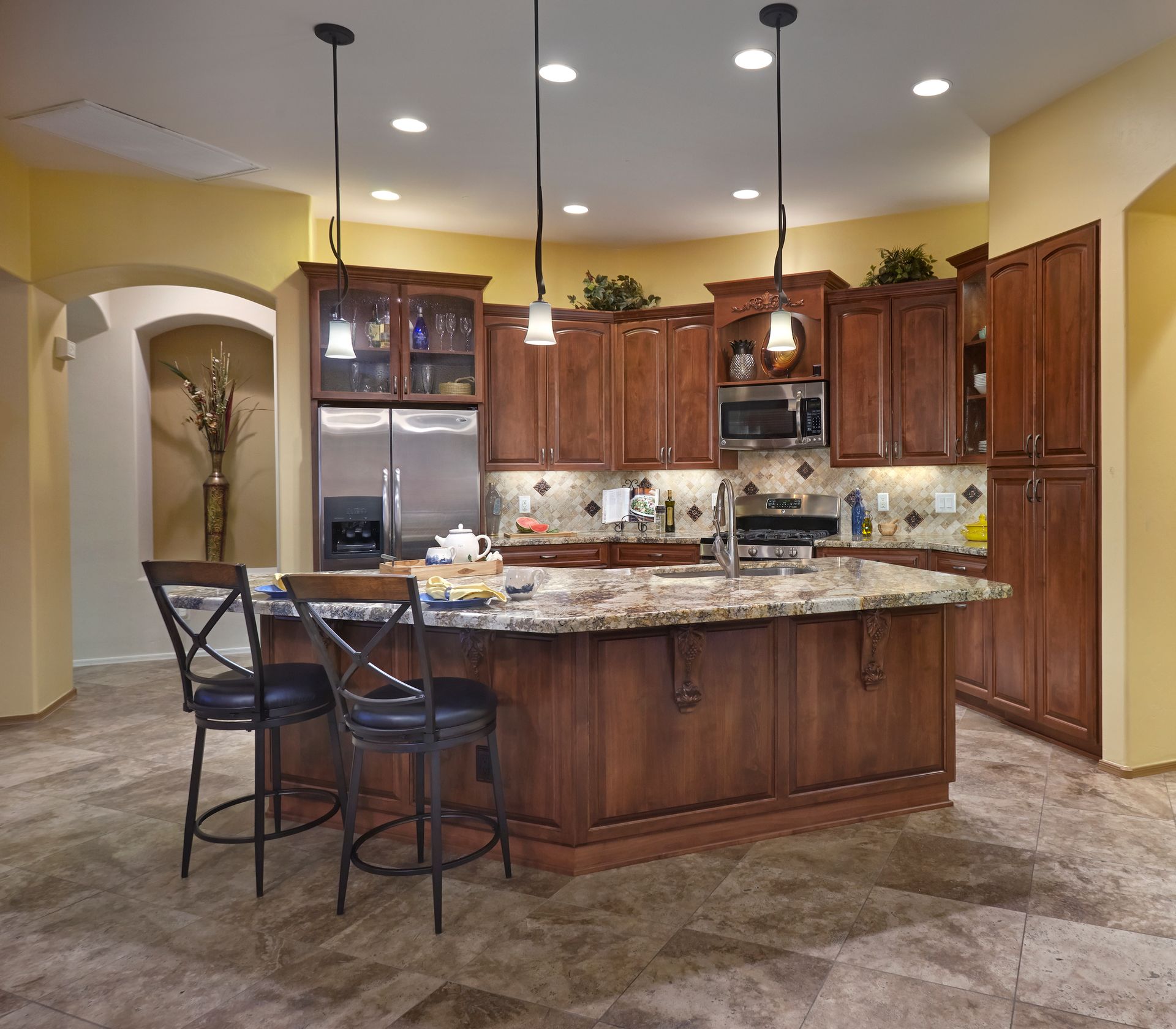 A kitchen with stainless steel appliances and wooden cabinets