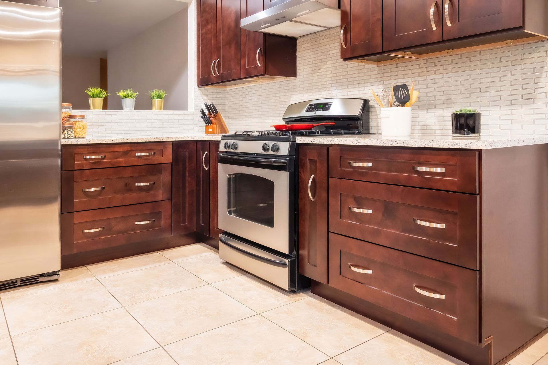 A kitchen with stainless steel appliances and wooden cabinets
