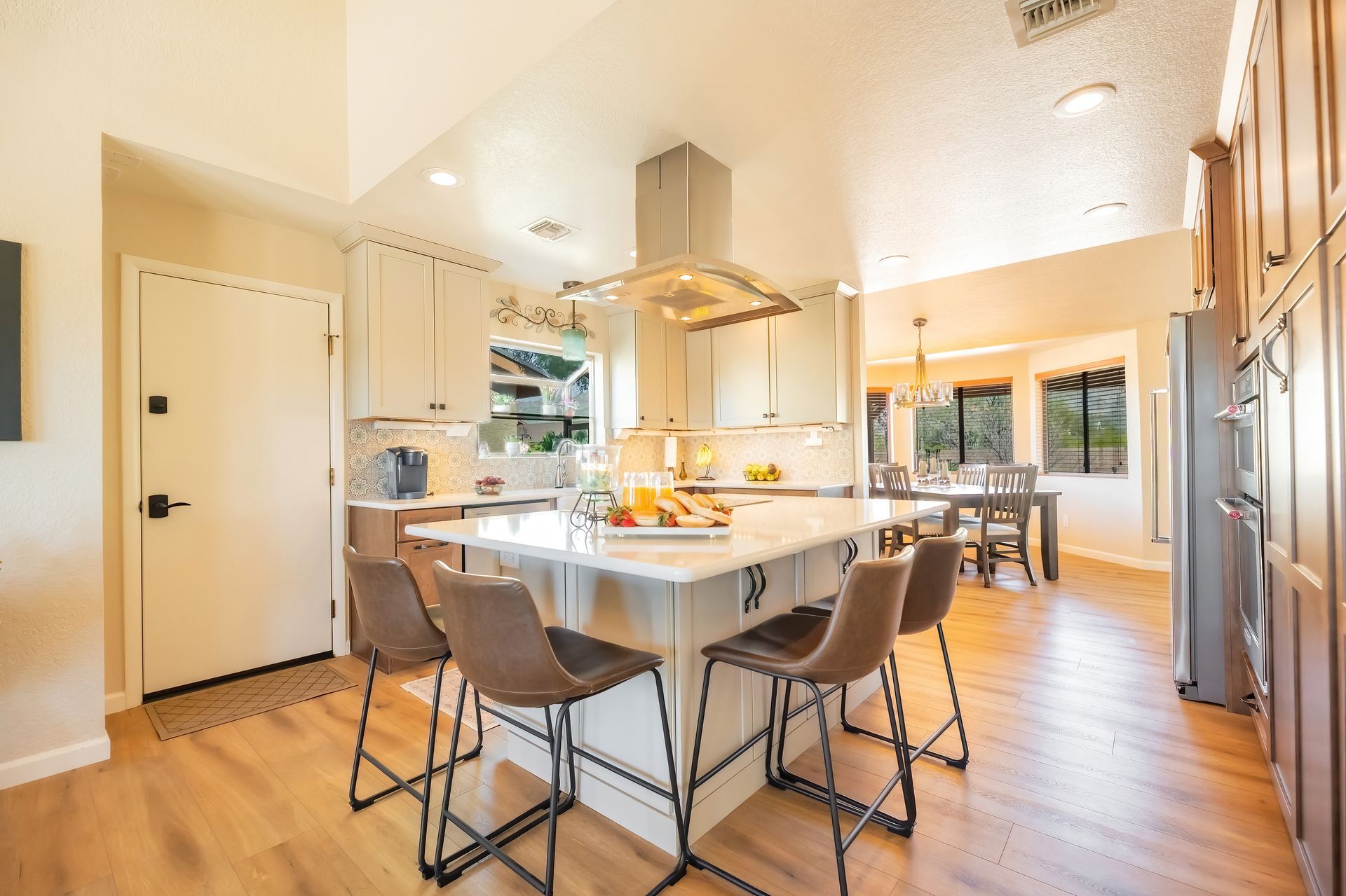 A kitchen with a large island and stools