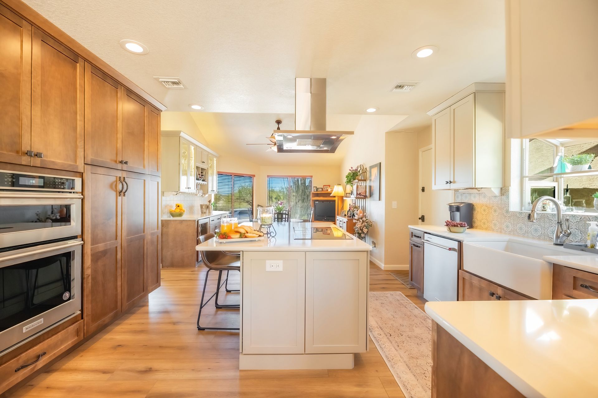 Spacious kitchen with wood cabinets, center island, stainless steel appliances, and natural light.