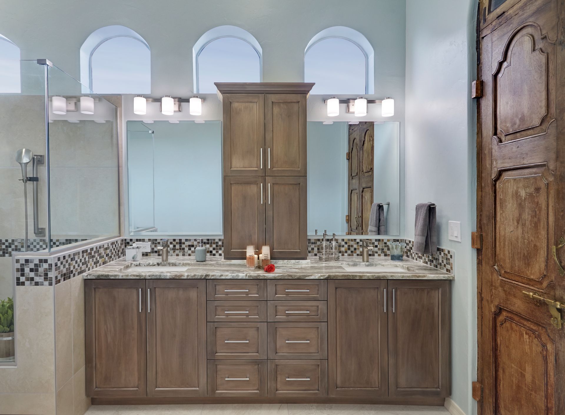 A bathroom with two sinks and a large mirror.