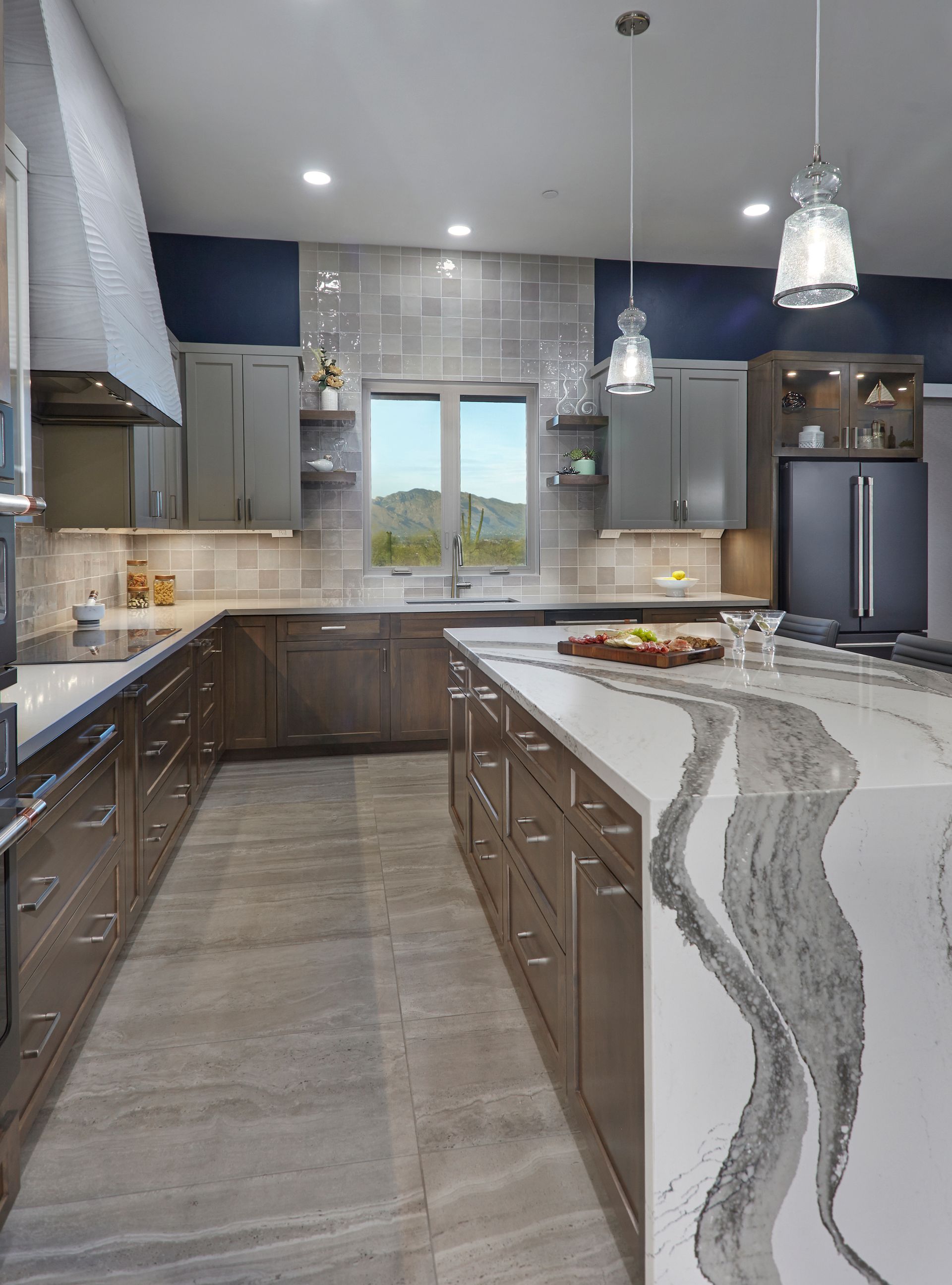 A kitchen with a large island and stainless steel appliances