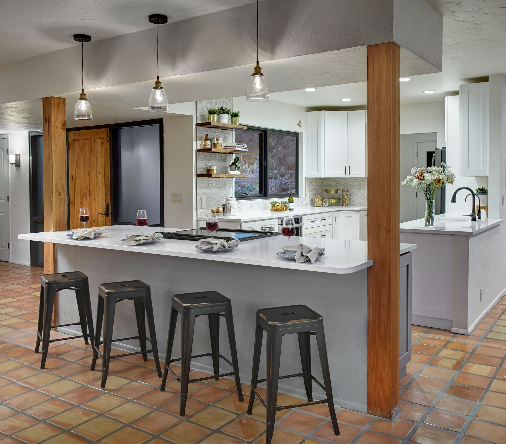 A kitchen with a large island and stools