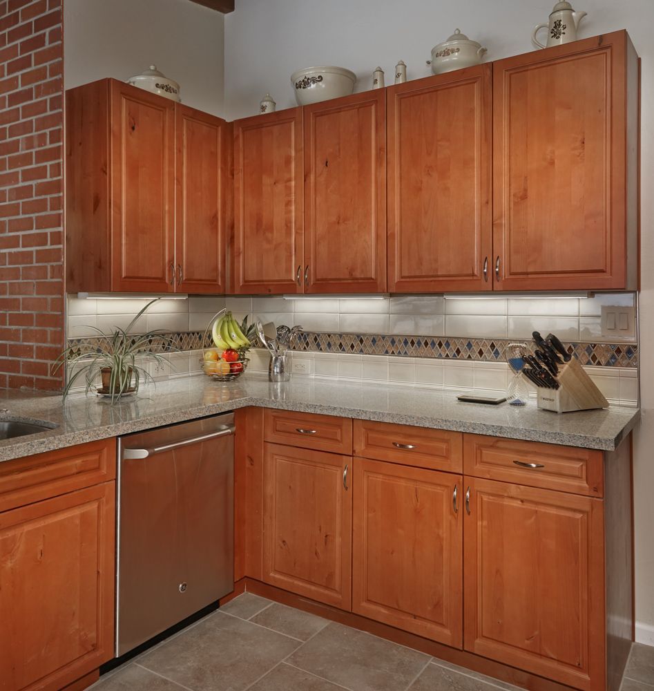Kitchen with wood cabinets, stainless steel appliances, and granite countertops.
