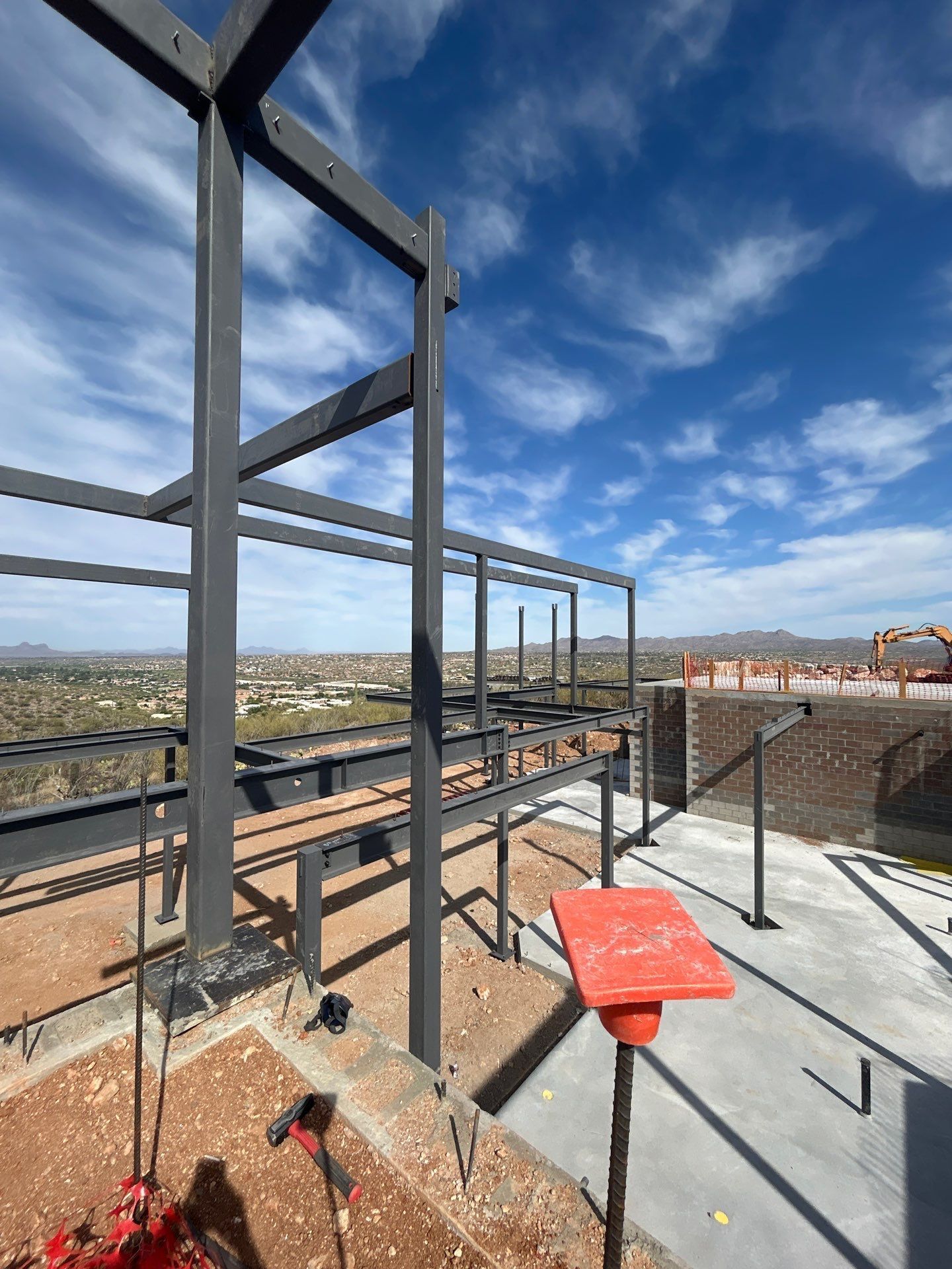 A metal structure with a red table in front of it