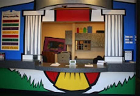 A colorful reception desk with columns and a smiley face on it