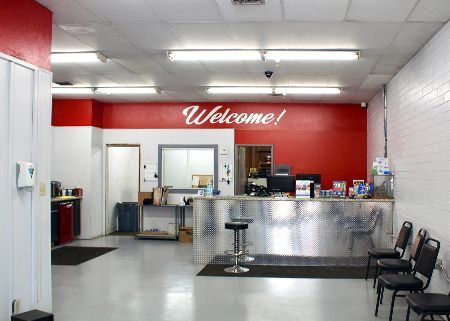 A large room with a red wall that says welcome