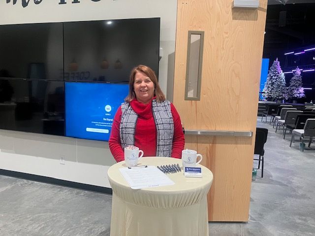 Person analyzing financial data with laptop, tablet, calculator; upward trending graph with percentage symbols.