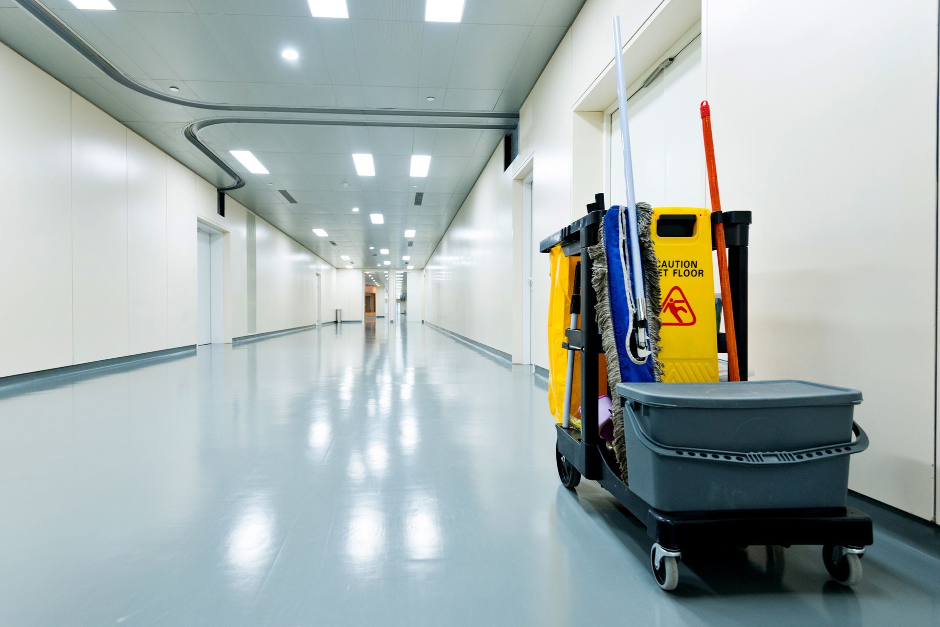 A group of people are cleaning a large office.