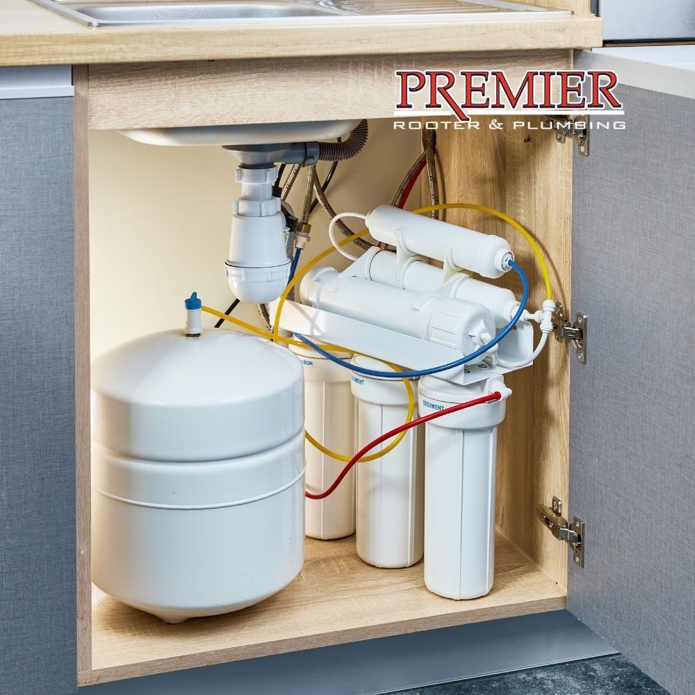 Undersink reverse osmosis water filtration system installed in a cabinet.