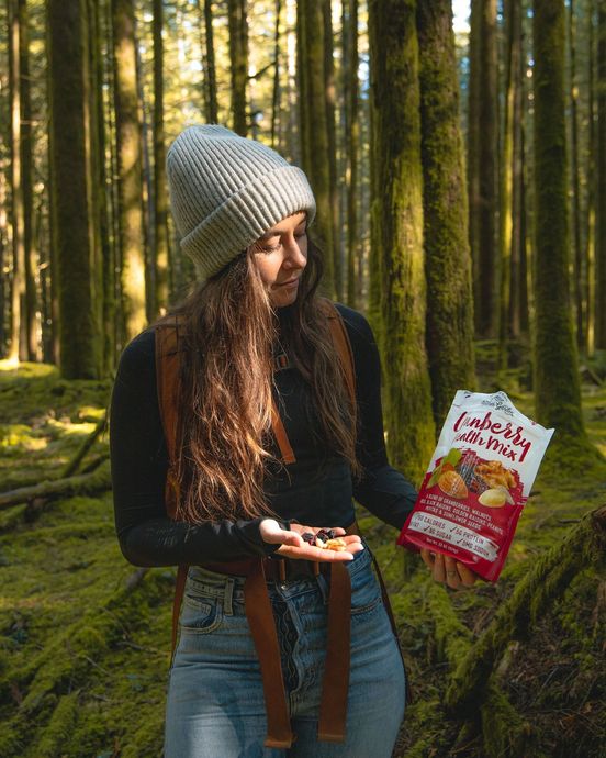 A woman in the woods holding a bag of lucky charms