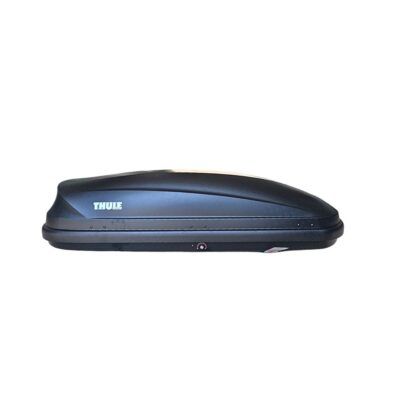 A black thule roof box on a white background.