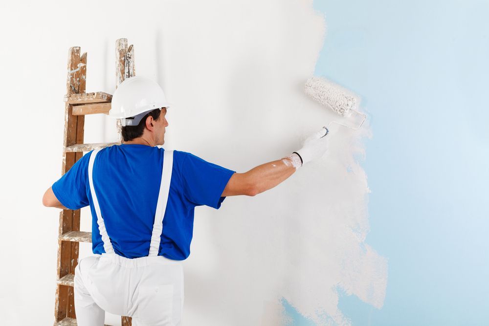 Man painting house — Residential Painting in Bonogin QLD