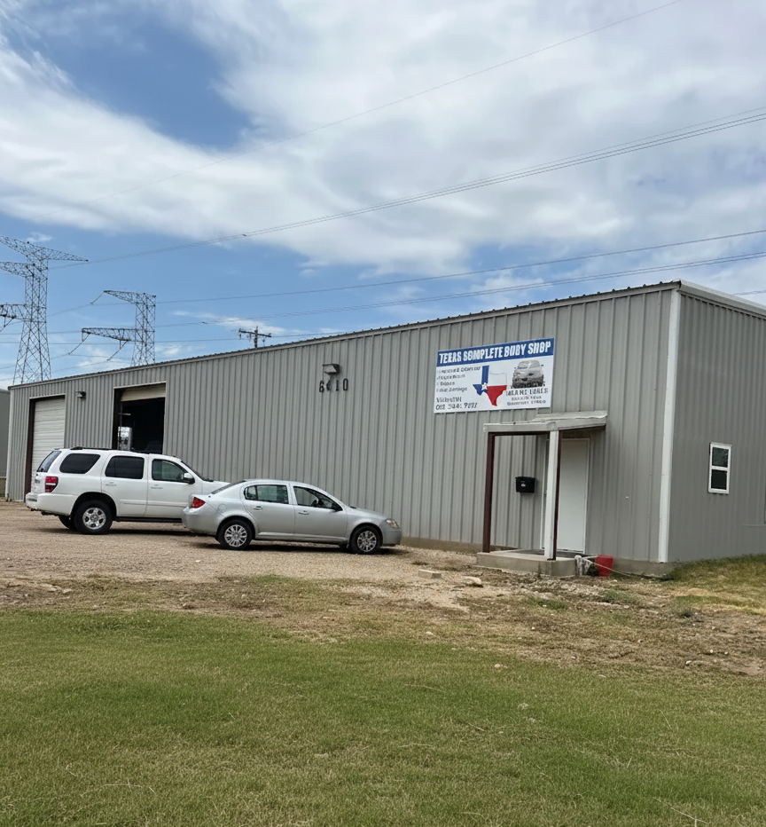 A silver industrial building with a sign for