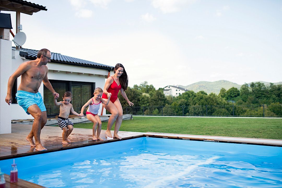 Family jumping into the pool although their deck needed to be upgraded to slip-resistant coatings 