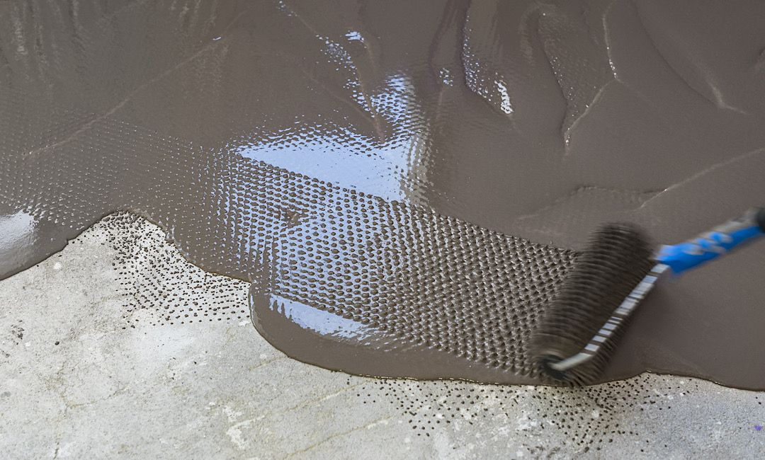 Rolling new Concrete Coating in Denver over old floor