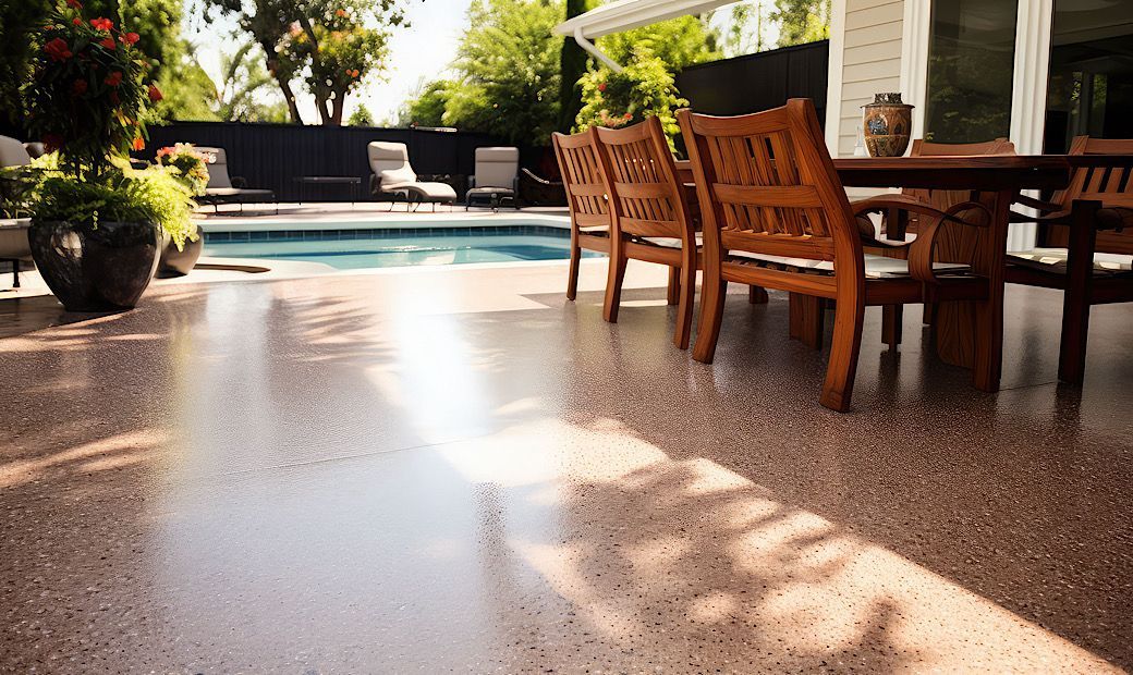 table and chairs on concrete coated flooring for outdoor patio