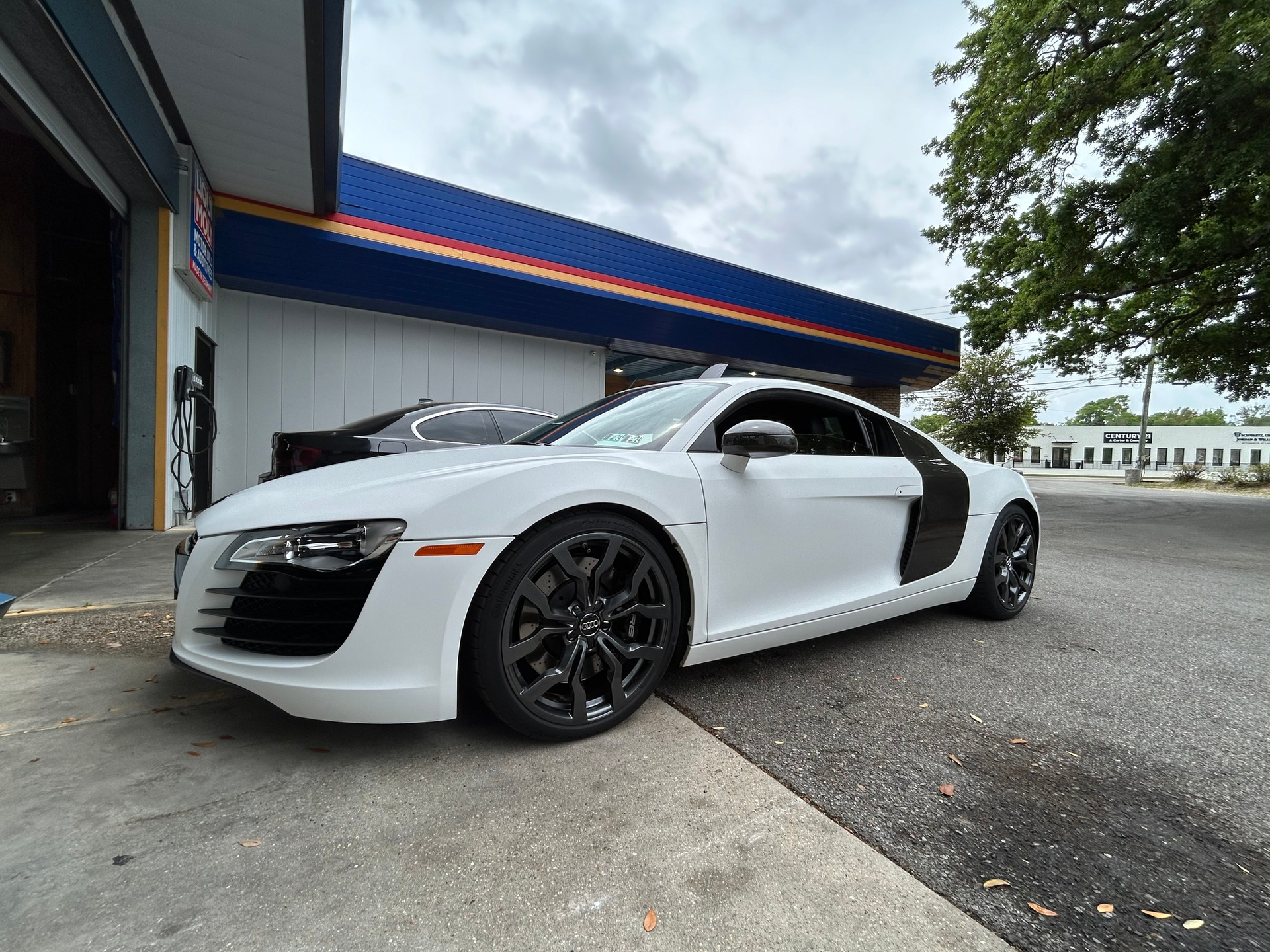 White Audi R8 coupe parked in front of the shop | Randall's Autohaus