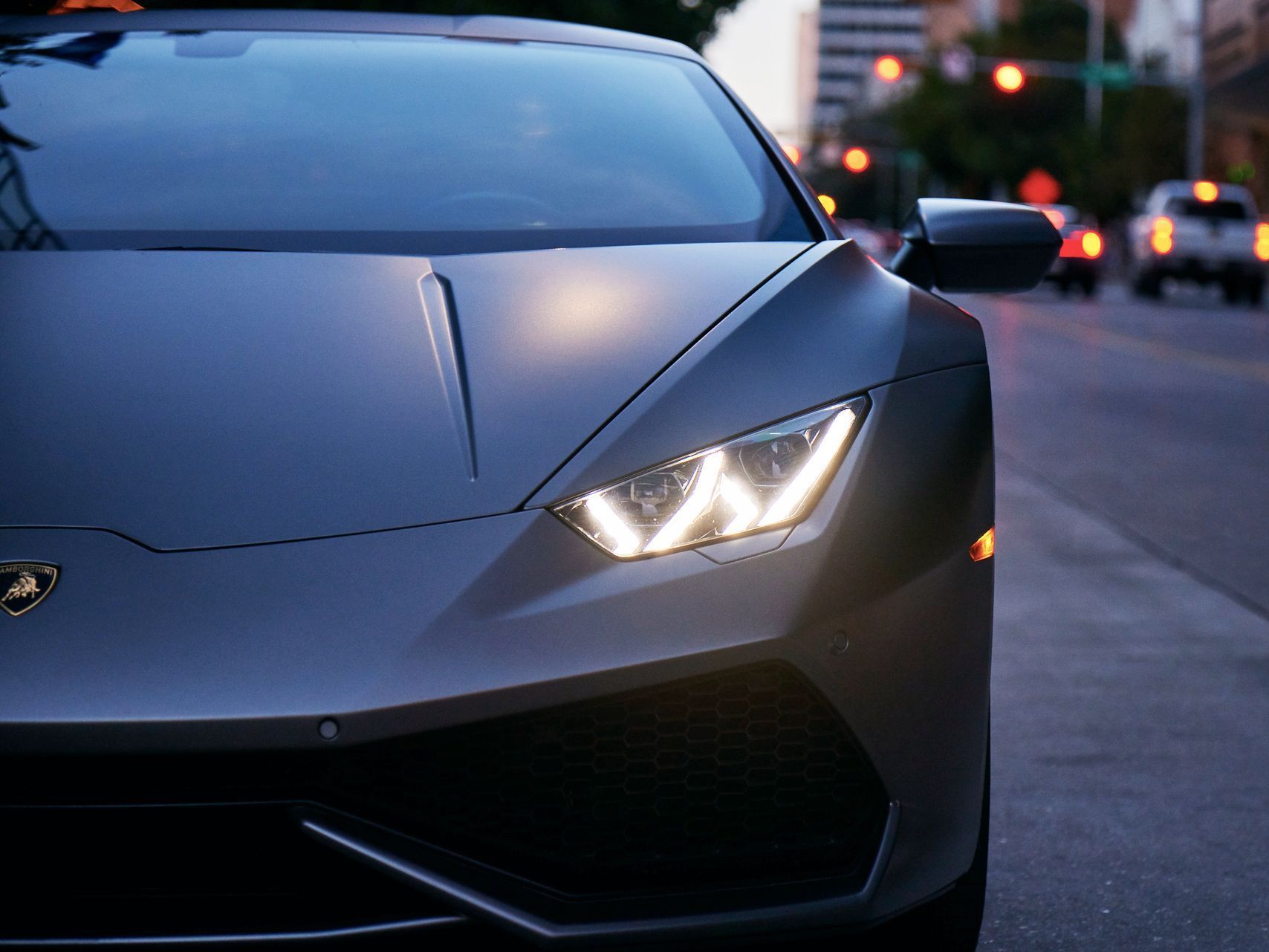 A black sports car is parked on the side of the road