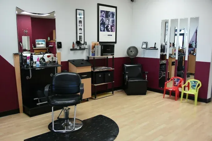 A barber shop with a chair and chairs for children