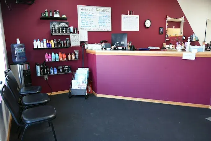 A waiting room with a purple counter and chairs