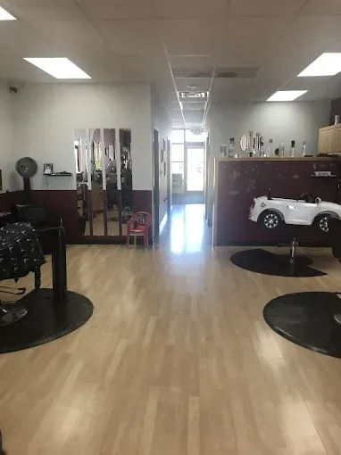 A barber shop with a toy car on the wall.