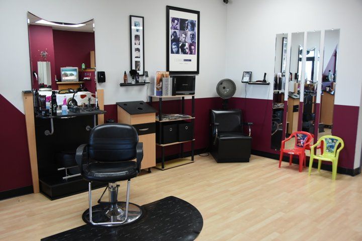 A hair salon with a chair in the middle of the room