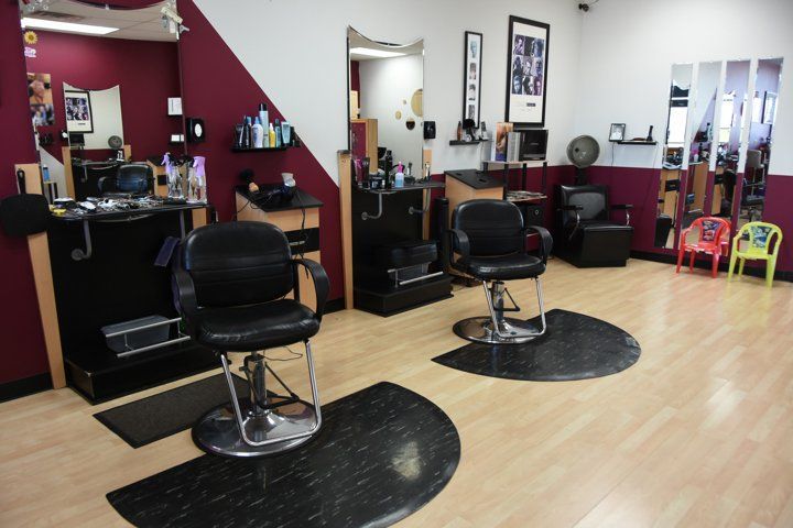 A barber shop with a lot of chairs and mirrors