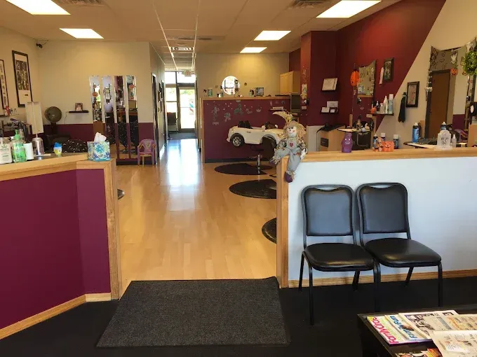The inside of a hair salon with two chairs and a counter