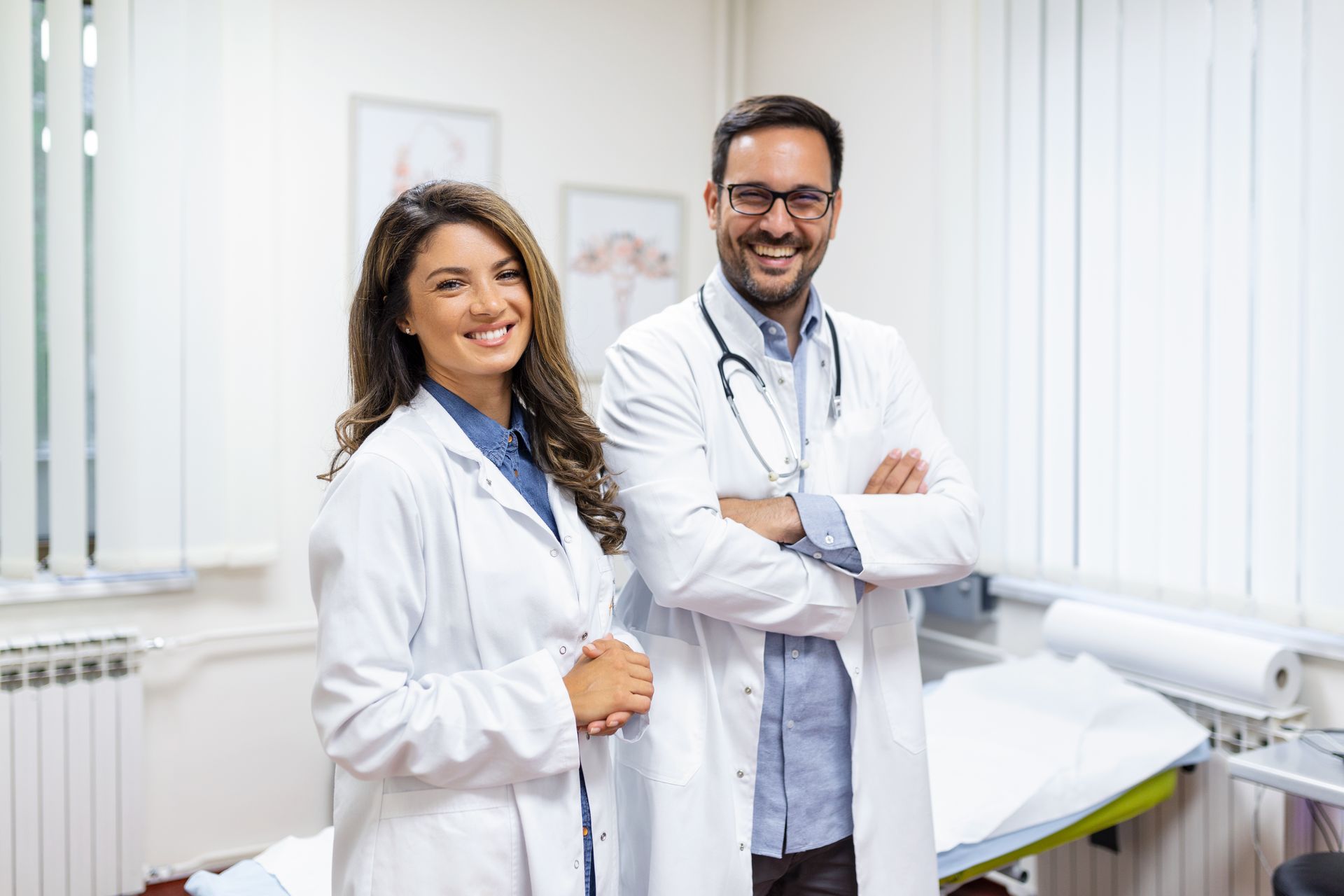 a man and a woman are standing next to each other in a doctor 's office .