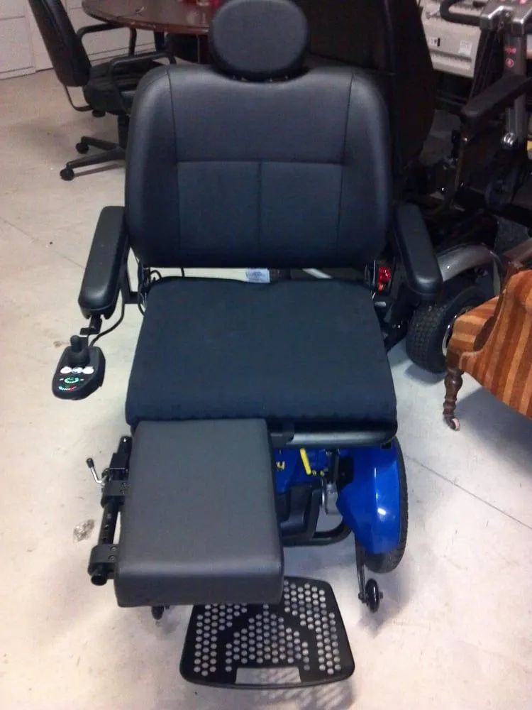 A black chair with a blue scooter attached to it