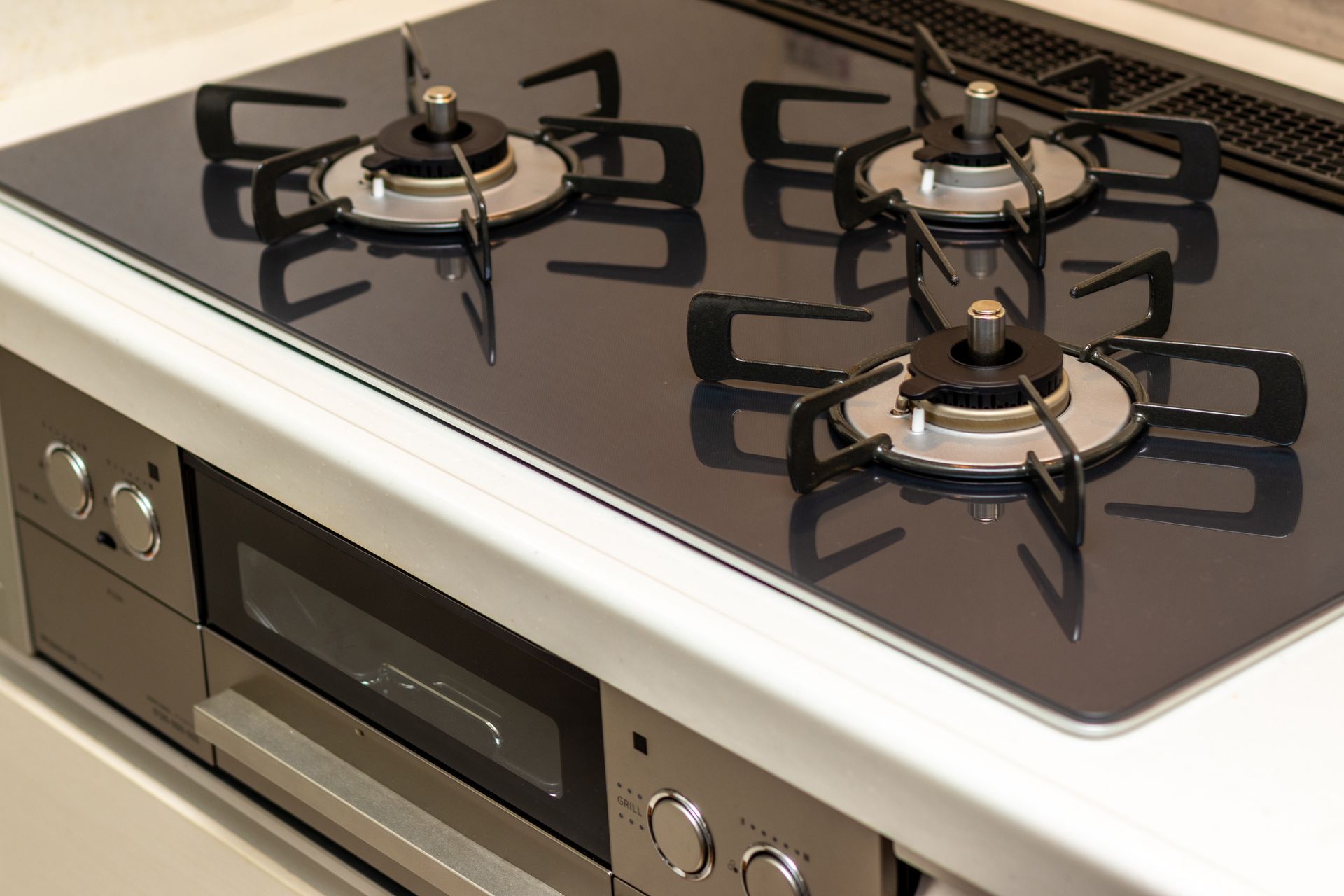 A close up of a gas stove with four burners