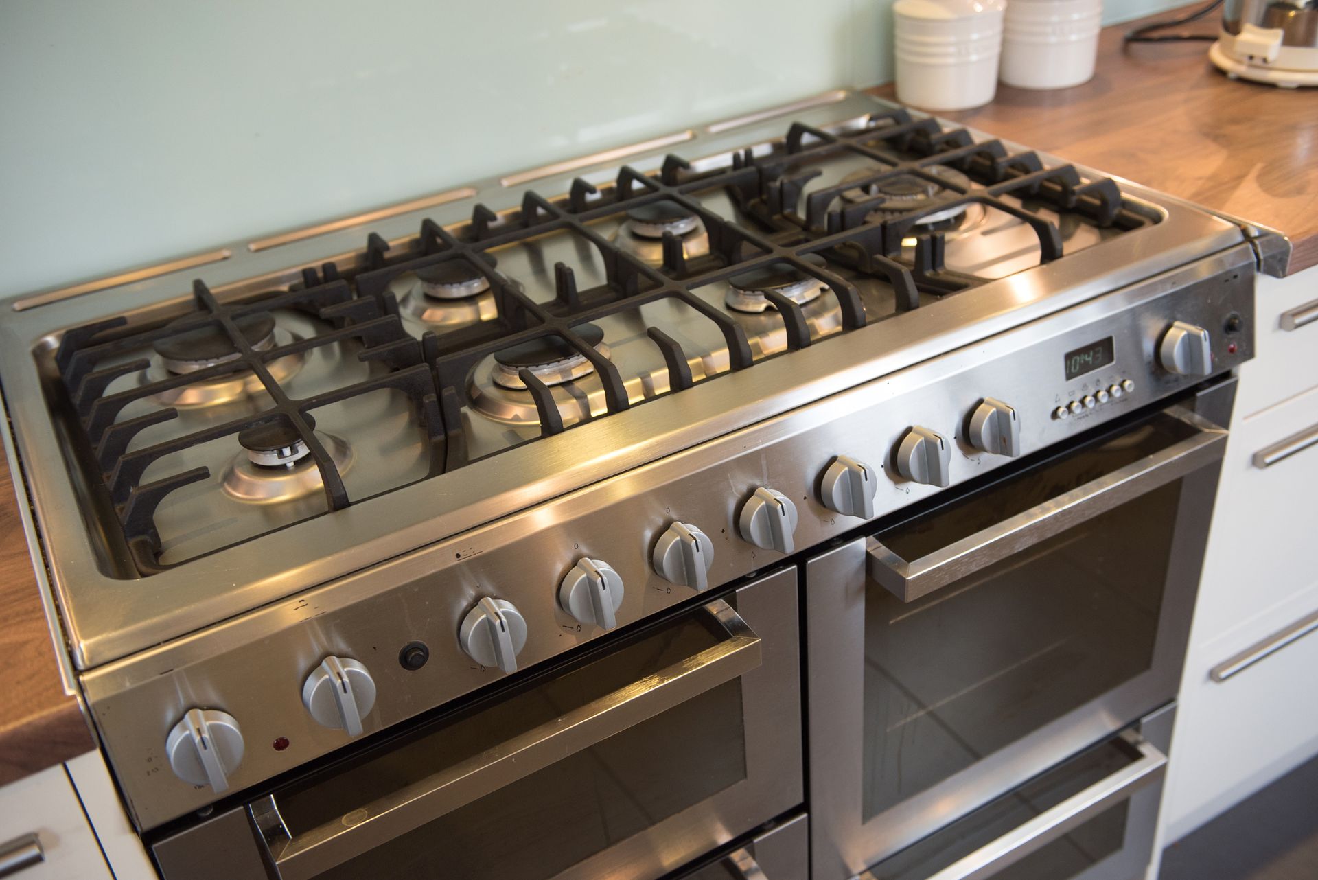 A stainless steel stove top oven is sitting on a kitchen counter.
