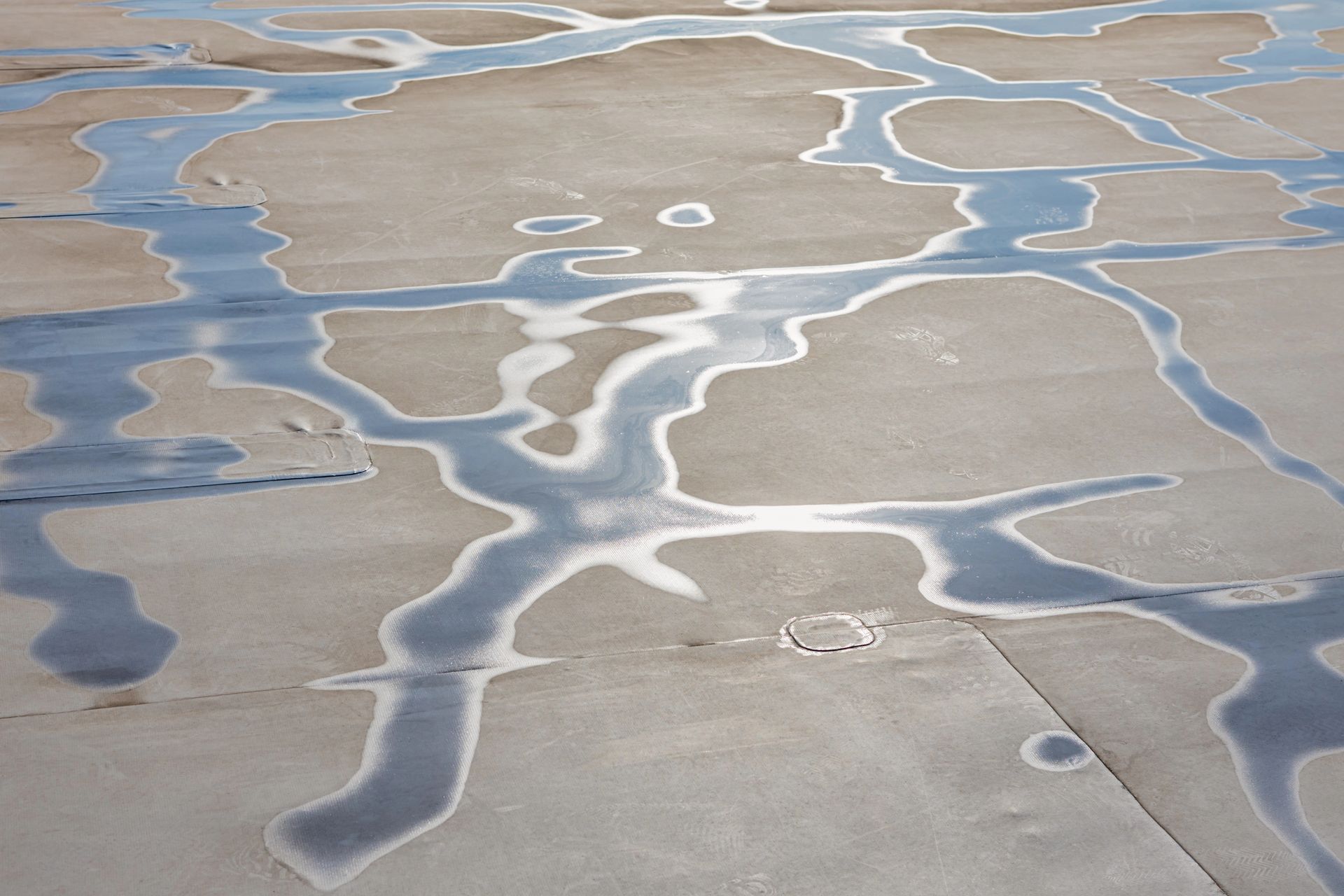 water puddling on a membrane roof