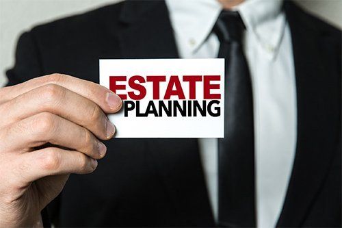 Man Holding Card With Estate Planning — Newark, CA — Daniel Kisner Law