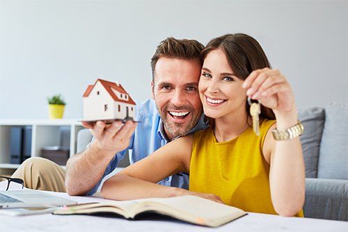 Couple Holding Key And House Model — Newark, CA — Daniel Kisner Law